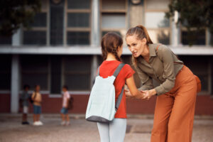 Parent talking to child at school